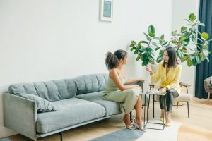 Dietitian counseling a patient while sitting on a blue couch