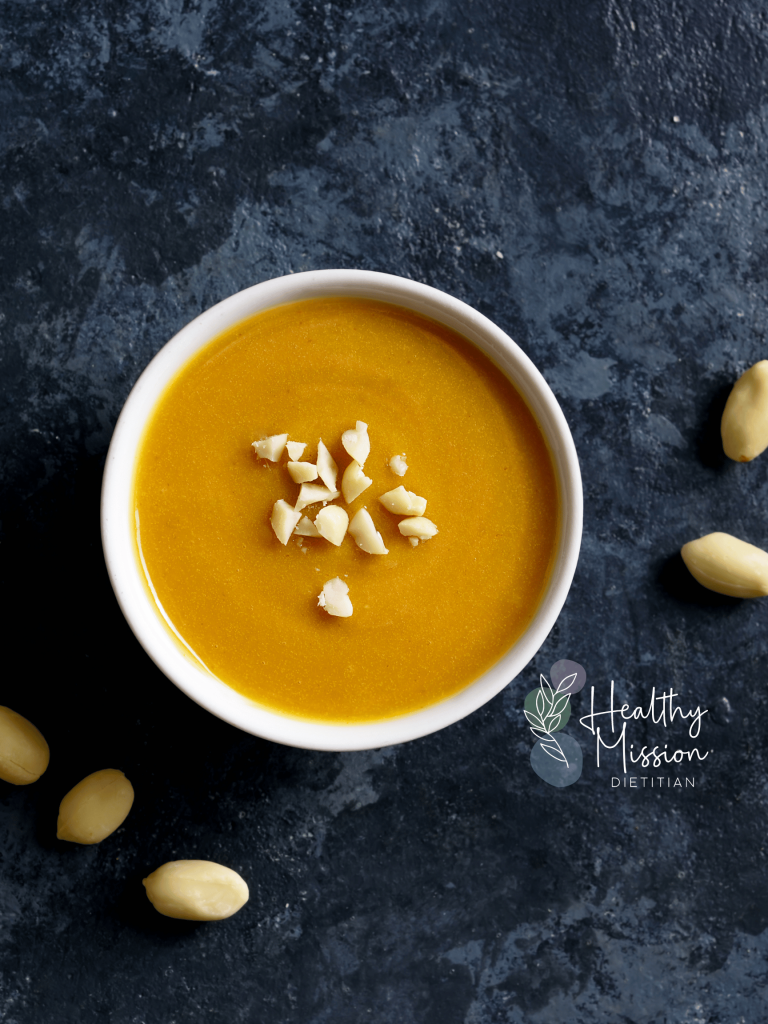 peanut sauce topped with crushed peanuts on a blue background