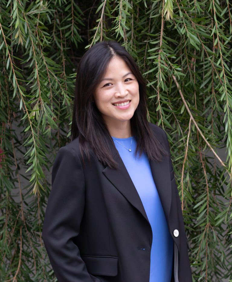 Portrait of professional Asian woman in a black blazer and blue blouse